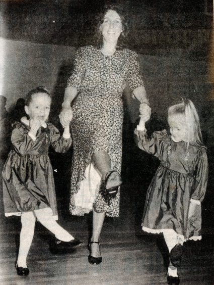 Reunion: Twins Teresa and Yvette Pack, 5, join in the fun with Ann Cousins, one of the dance class of '49.