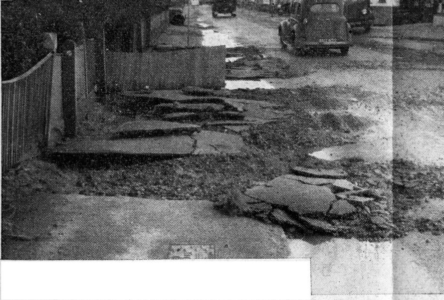 So violent was the rush of water in Canvey High Street that it forced up the pavement and flung it into the road. | Shiner and Holmes