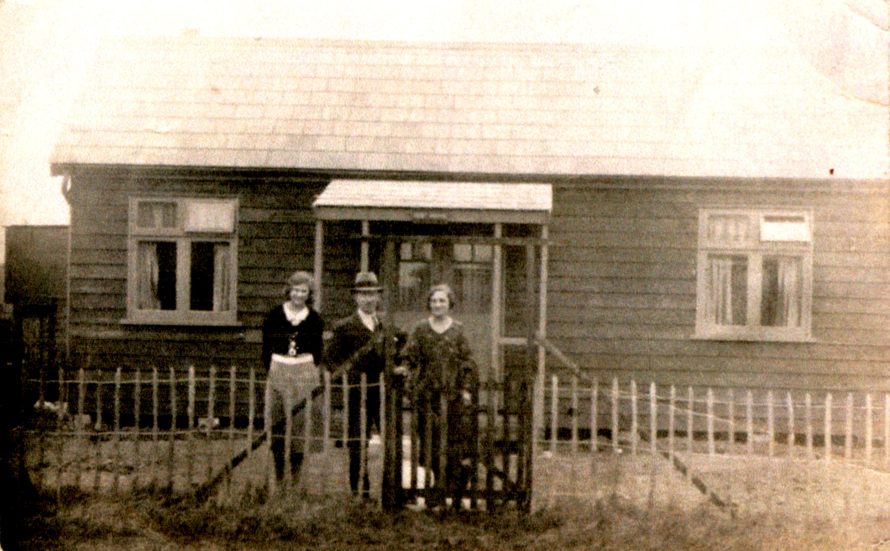 Mike's mum with her parents Charles and Minnie Stockbridge at the front of the bungalow