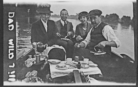 The Pound family at a picnic on the Thames, Alice and Charles Pound with daughter Alice and a friend. (The very likely home-processed film negative seems to have been tampered with and the film negative mark 'A' and the 'IL' for Ilford have been turned into the words 'DAD' and 'WILD'.)