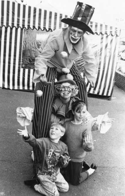 Up in the air: Tall clown Jacko and his daughter Wacko teach brother and sister Lee and Donna Cox how to juggle. | Echo newspaper group