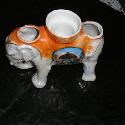 Elephant with picture of the Canvey Island Dutch Cottage and wording of the same. I believe this is a candle holder thou never been used. Height 3inch Width 5inch. Marked on base-foreign | Carol Rowles