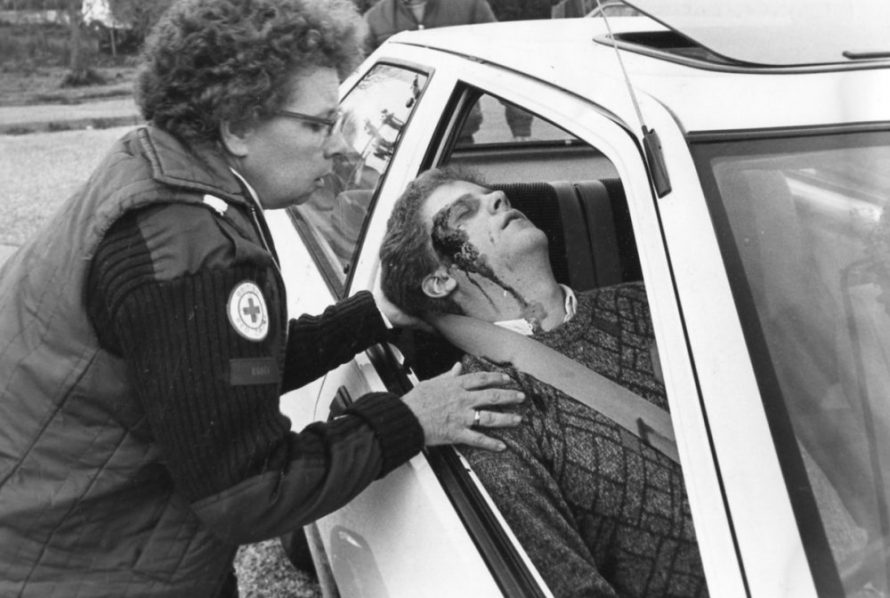 Betty Korten and Trevor Deacon. Tending to head wound | Echo Newspaper Archive