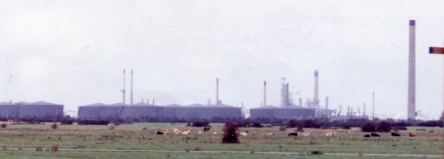 Close-up of the chimney and tanks of the Occidental site with Coryton in the background