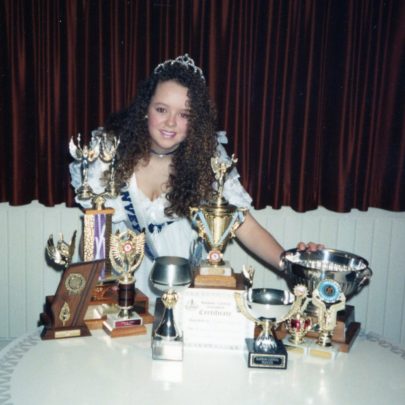 Andrea and her collection of cups and awards | Andrea Kitts